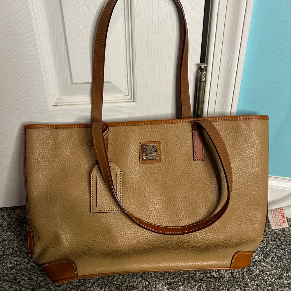 Tan leather dooney & bourke purse with pink interior